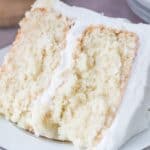 Slice of moist white cake on a white plate