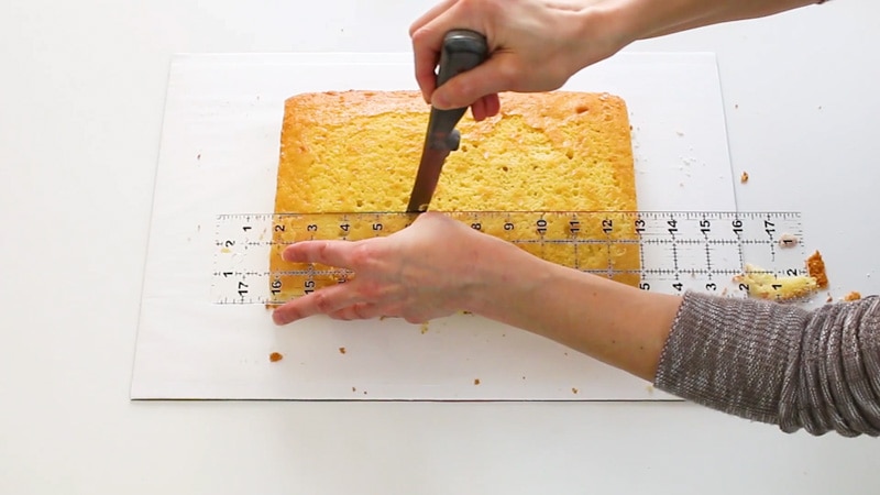 Cutting the cake into equal sections for the floral initial cake
