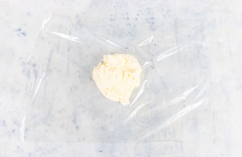 Adding buttercream to saran wrap