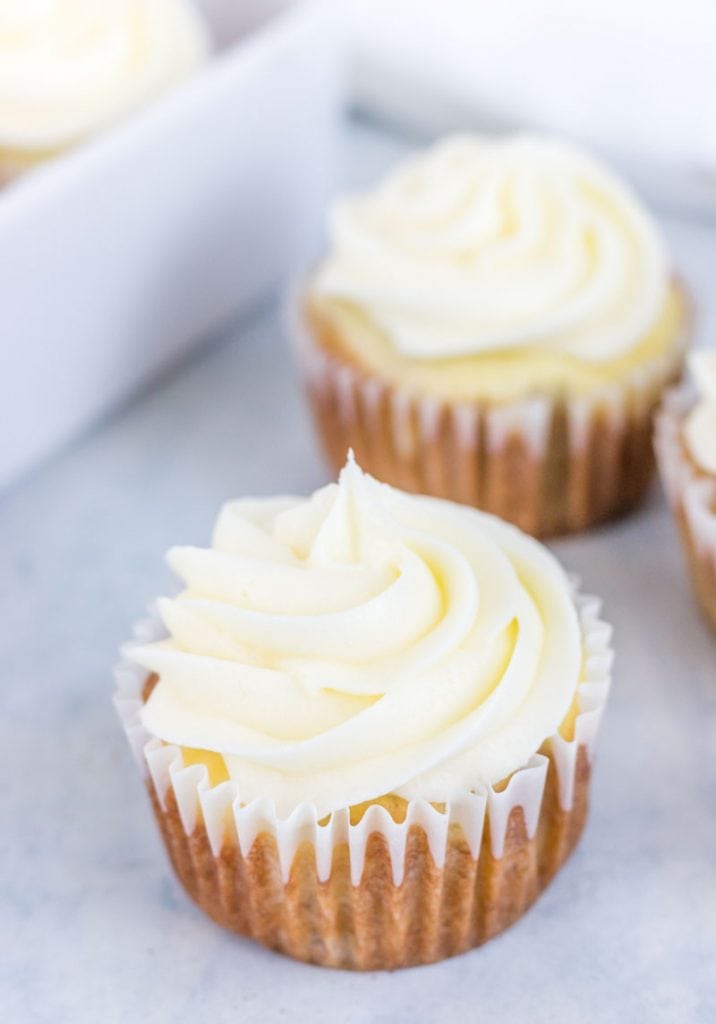 Piped cream cheese icing on a cupcake