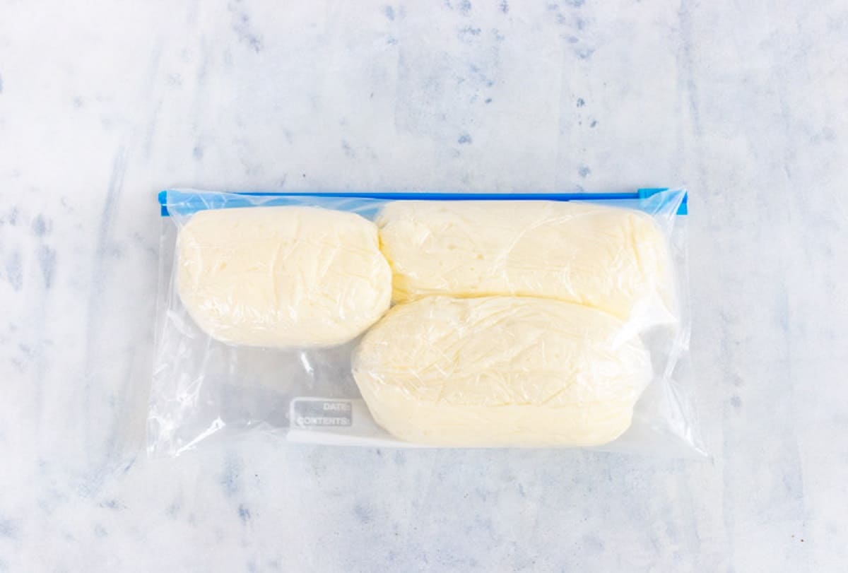 Mounds of buttercream in a ziplock bag.