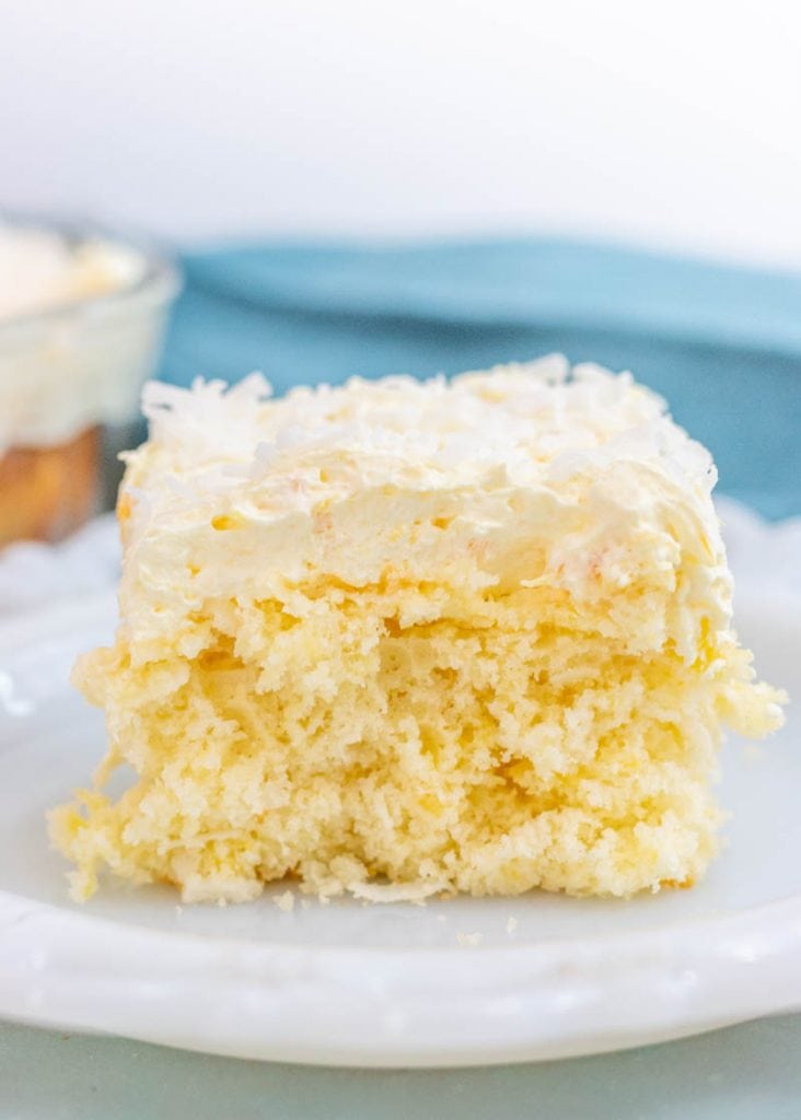pineapple coconut cake slice on a white plate