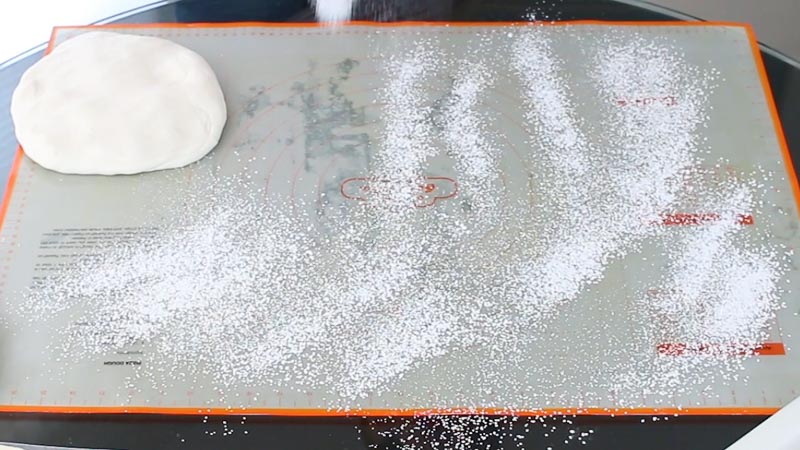 Sprinkle mat with cornstarch and powdered sugar mixture