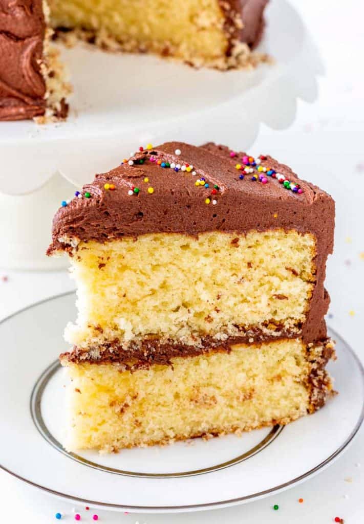 Classic Yellow Cake with Fudge Frosting on a white plate