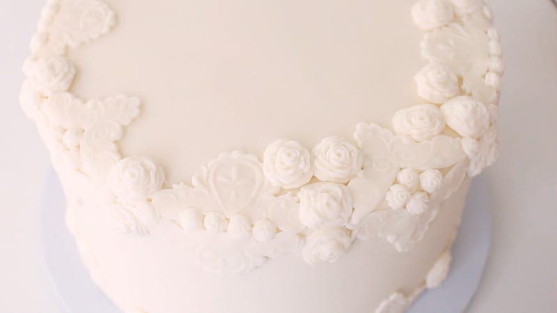 add the fondant roses to the bas relief cake