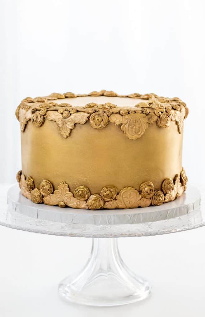 Antiqued Bas Relief Cake on a cake stand