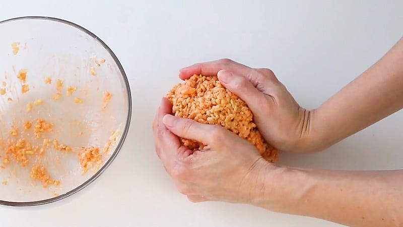 shaping rice krispie treats into a ball