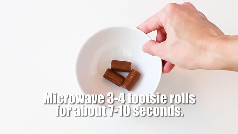 Microwave about 3 tootsie rolls