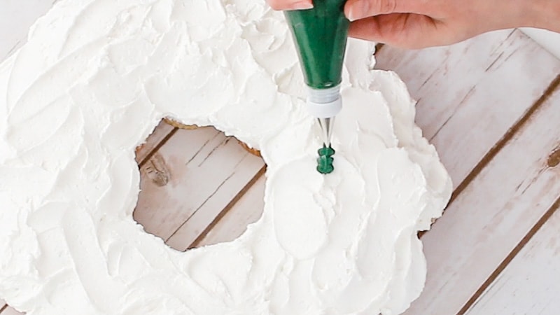 piping leaves onto wreath cupcake cake