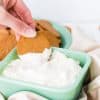 dipping cookie into cream cheese dessert dip