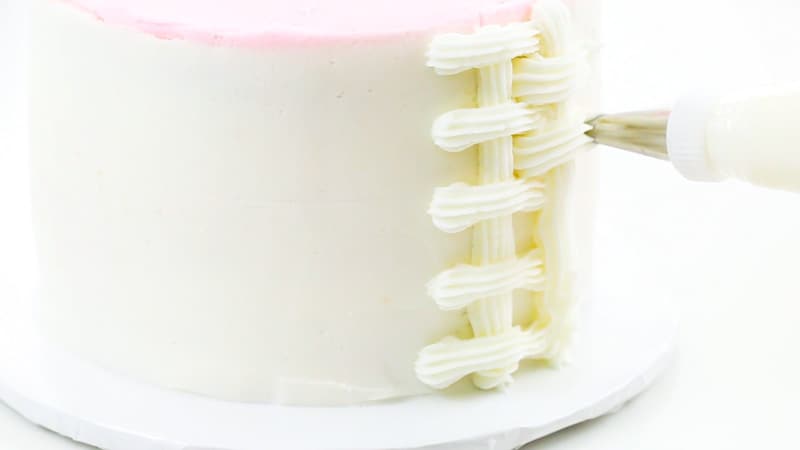 piping a basketweave on a cake