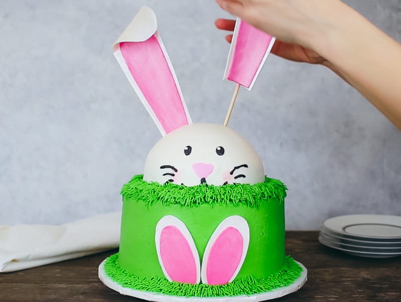 adding gumpaste bunny ears to cake