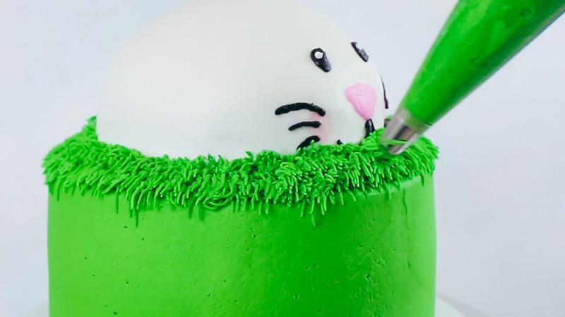 piping buttercream grass on bunny cake