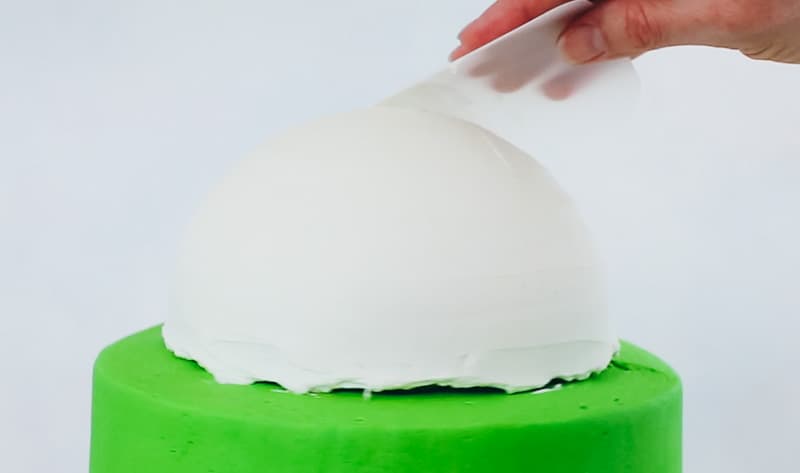smooth the buttercream on the bunny head cake