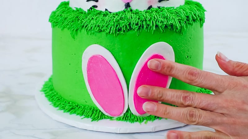 adding the gumpaste feet to bunny cake