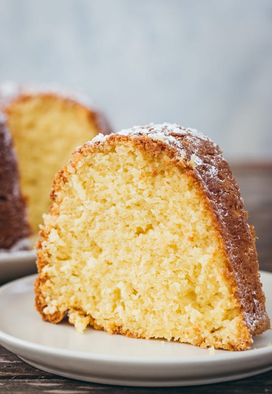 Slice of cream cheese bundt cake on a white plate