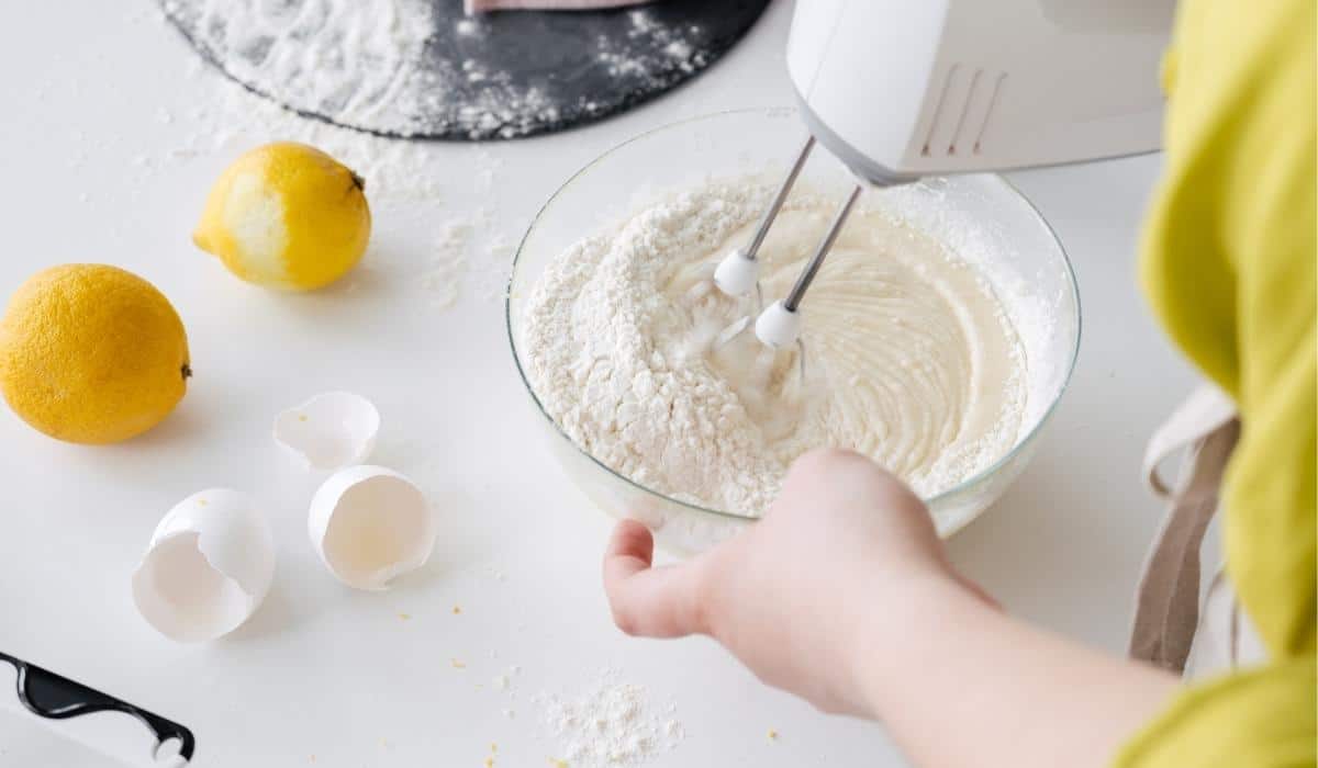 Mixing cake batter with a mixer and lemons.