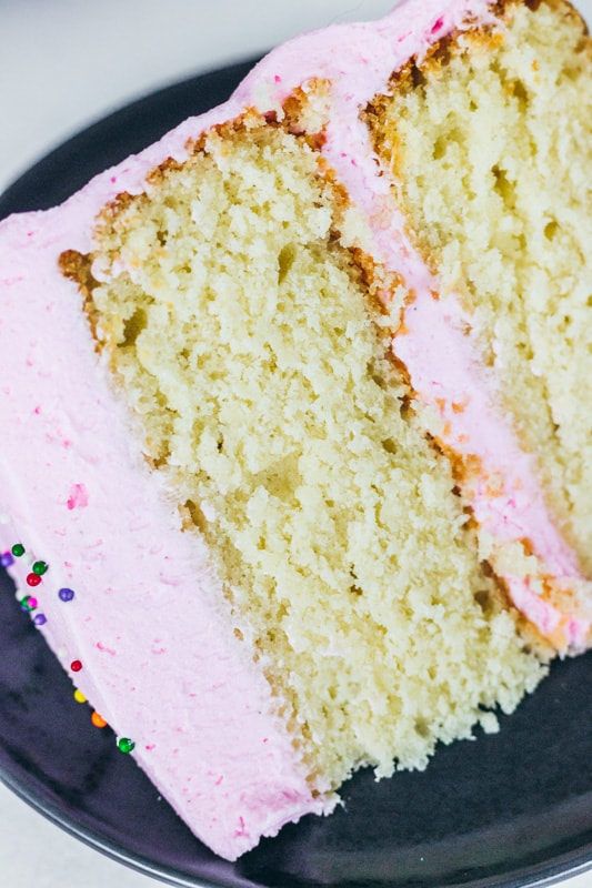 close up slice of vanilla cake on a plate