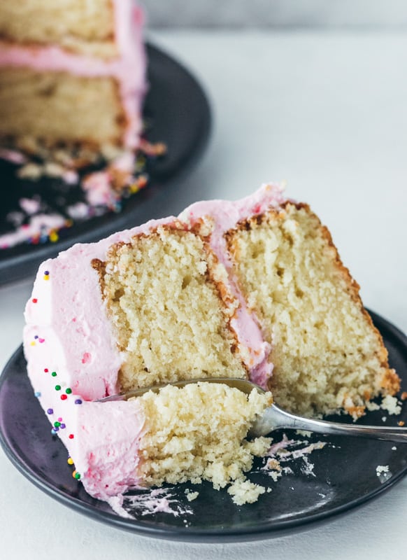 slice of vanilla cake with a fork on a plate