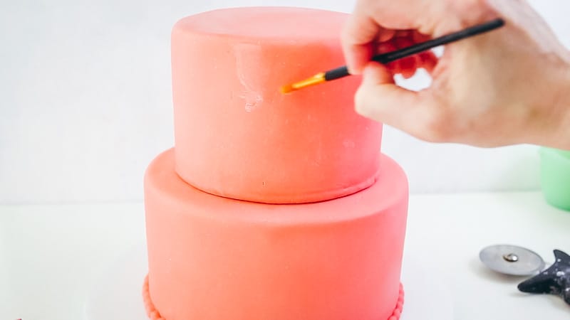 add water onto fondant cake to attach ruffles