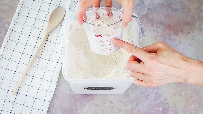 measuring flour in a measuring cup