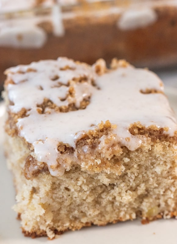 large slice of apple coffee cake on a white plate