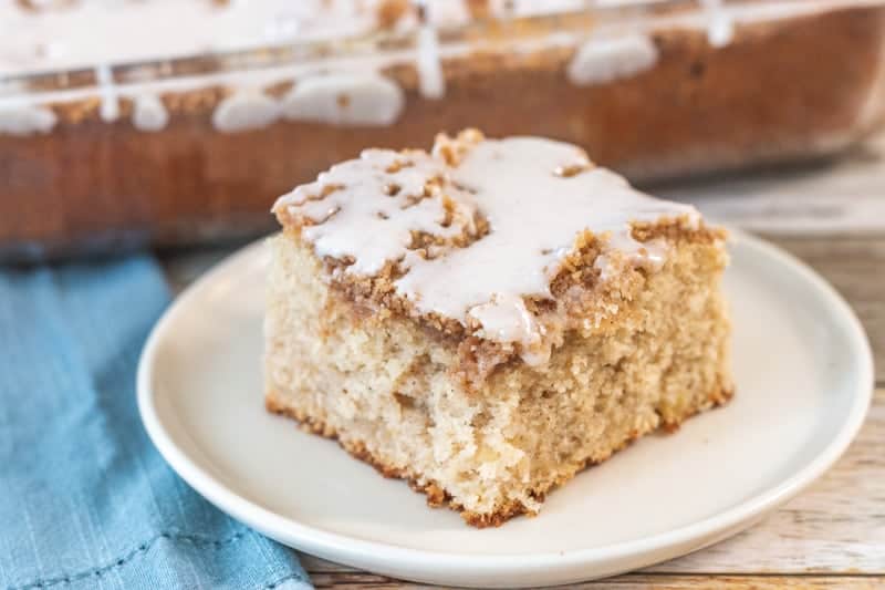 slice of apple crumb cake on a cream plate