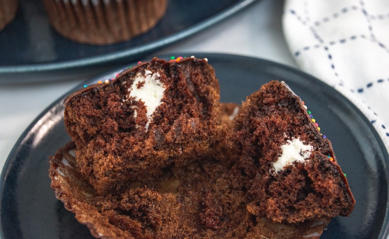 chocolate cream filled cupcakes on a blue plate