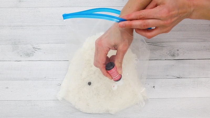 add food coloring to coconut in bag