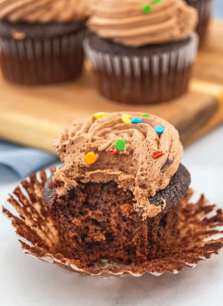 moist cupcake with icing and a bite taken out