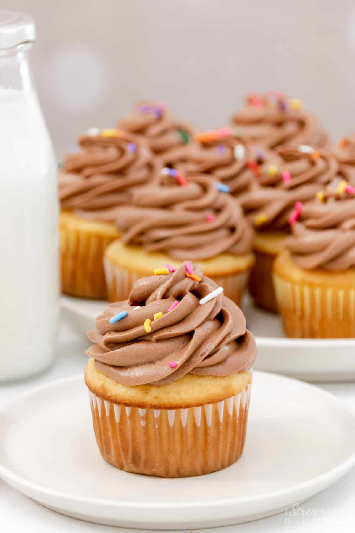 cupcakes with sprinkles on a white plate