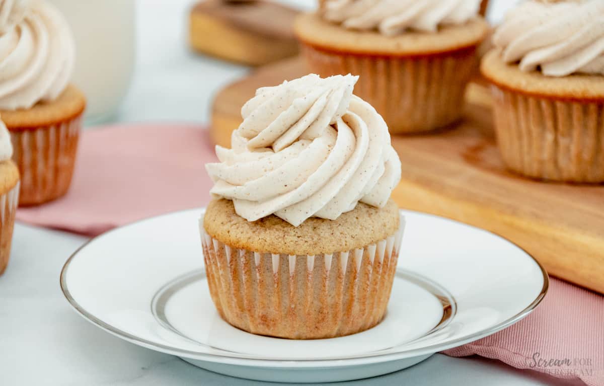 cinnamon cupcake with buttercream on a white plate
