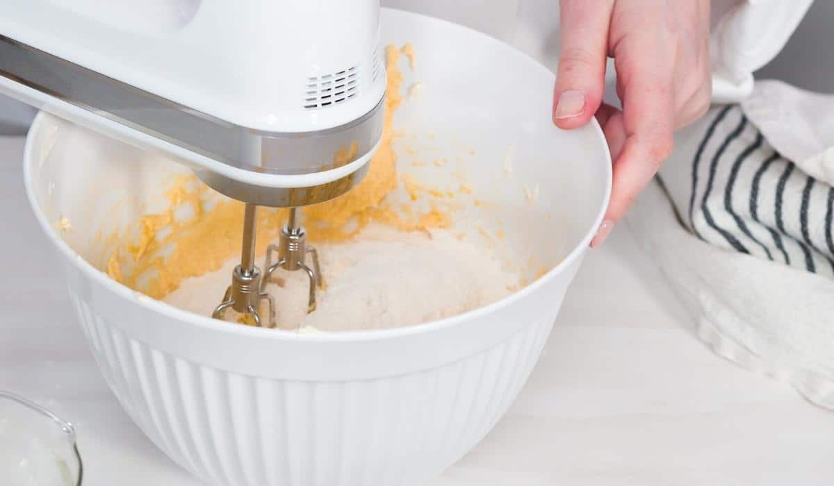 Mixing bowl with ingredients and mixer.