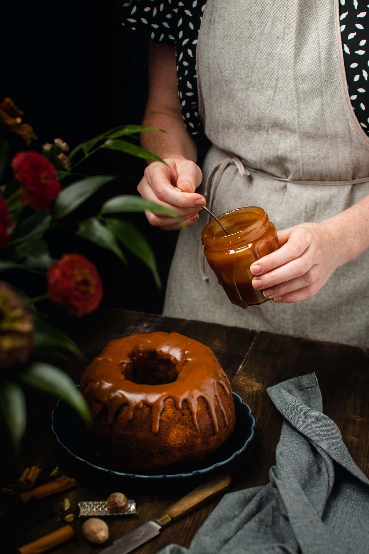 Adding caramel to top of cake.