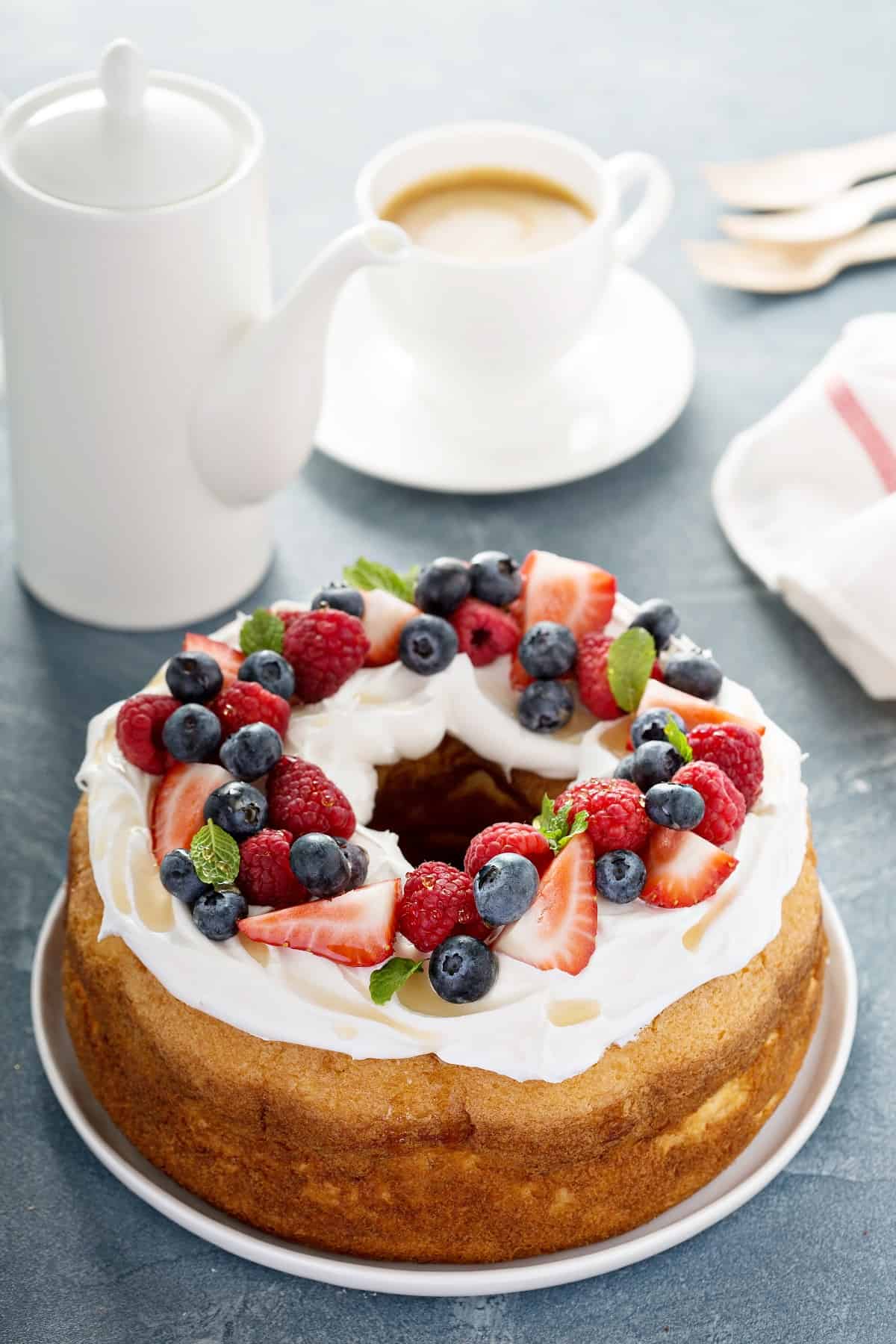 Whipped cream and fruit on bundt cake.