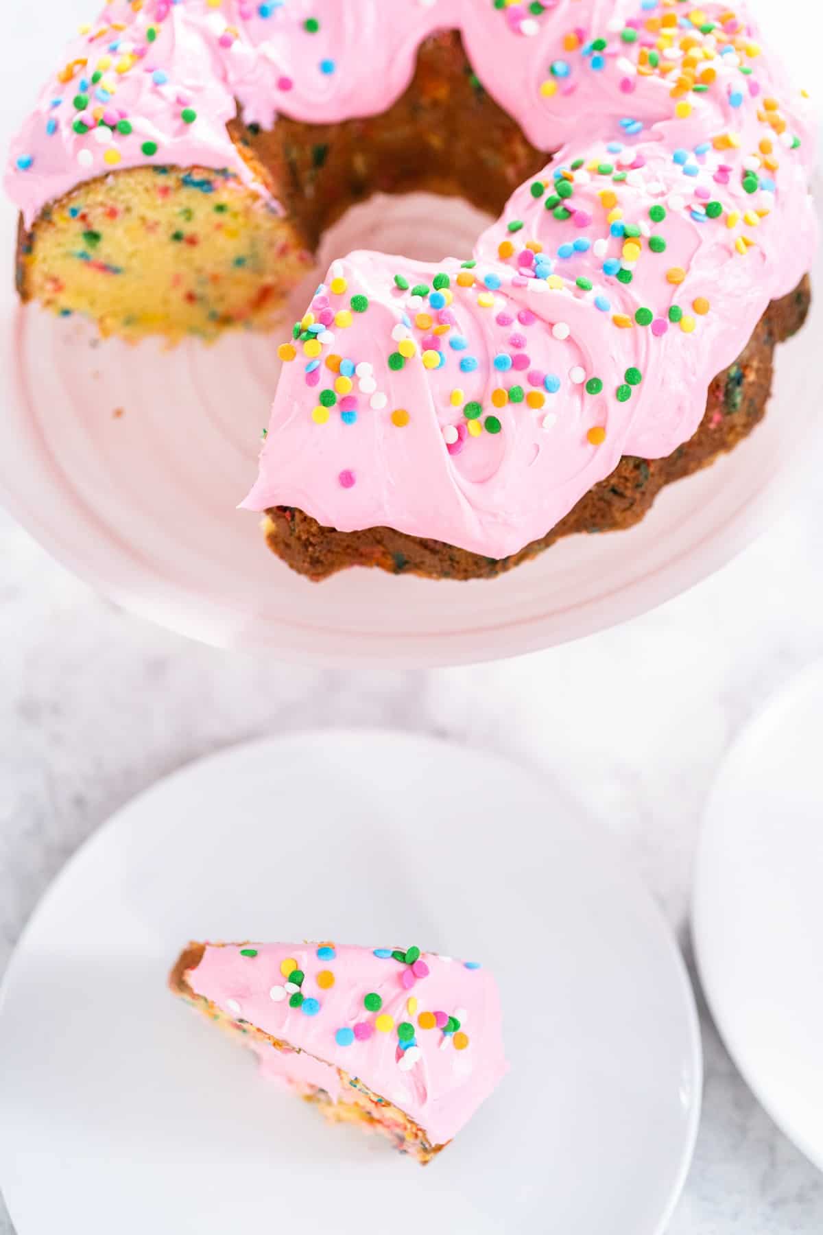 Pink buttercream icing on a bundt cake.