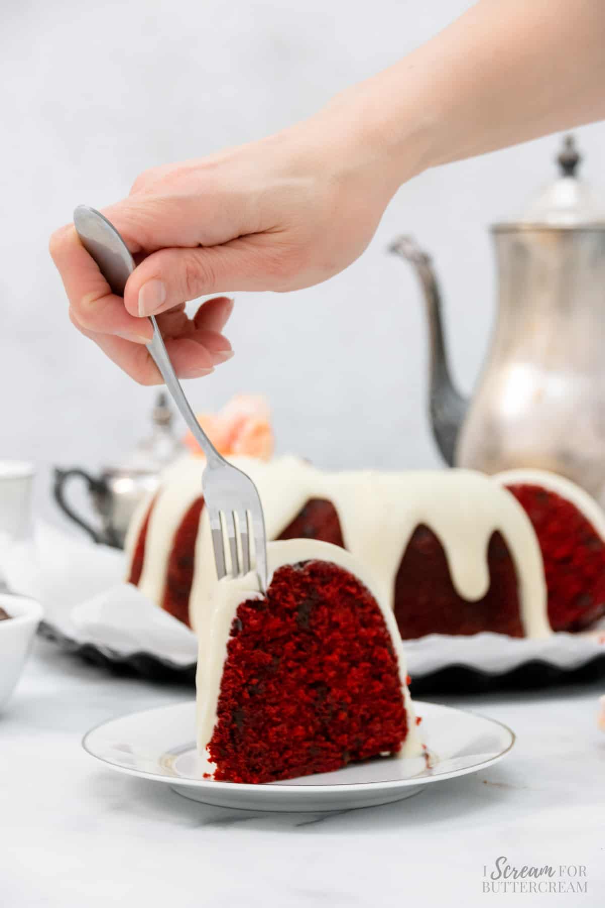 Cake slice on a plate with a fork.