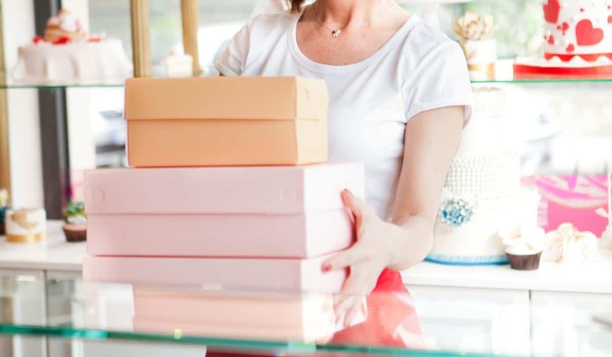 Woman holding bakery boxes.