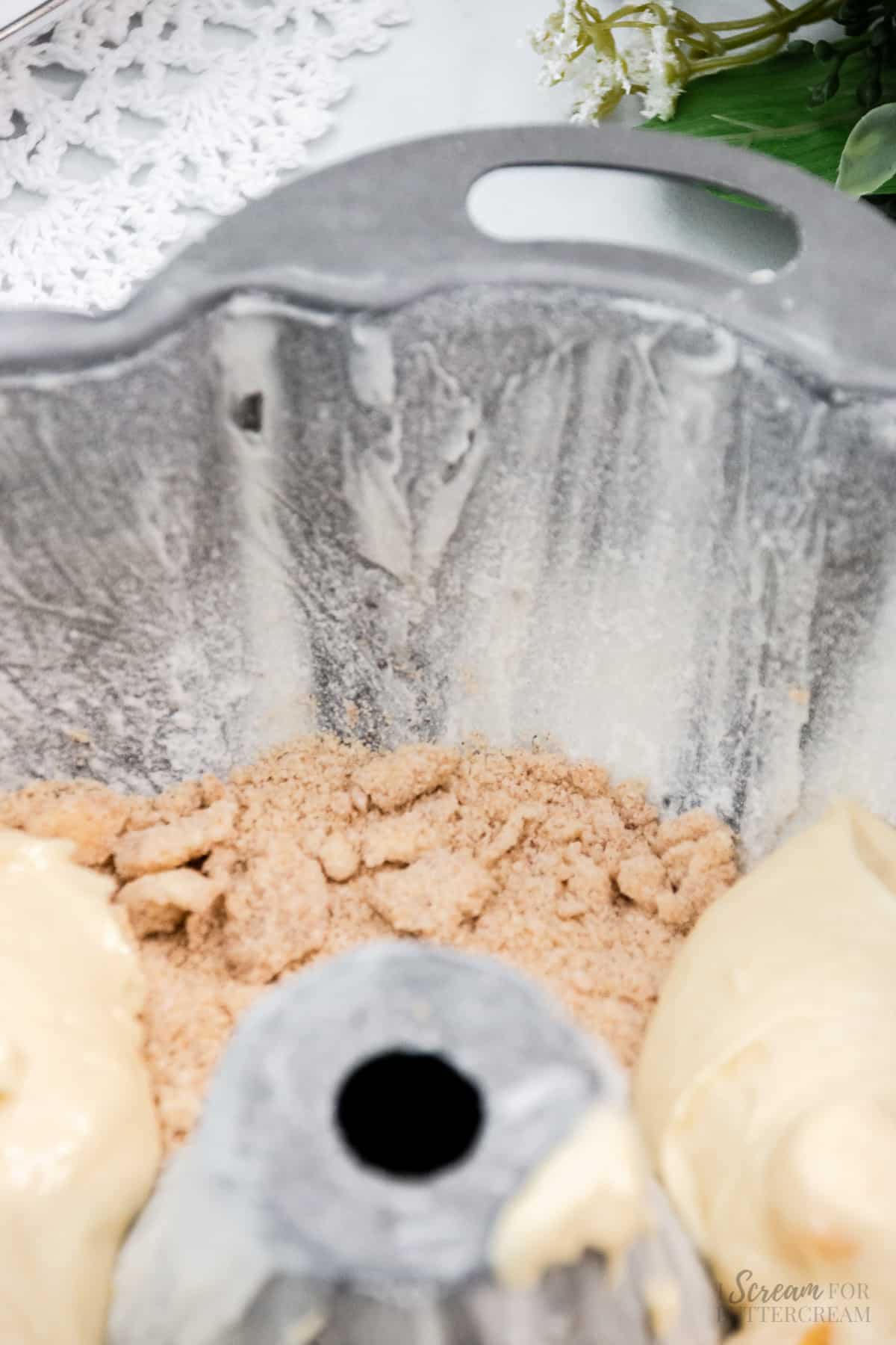 Bottom layer of streusel in a bundt pan.