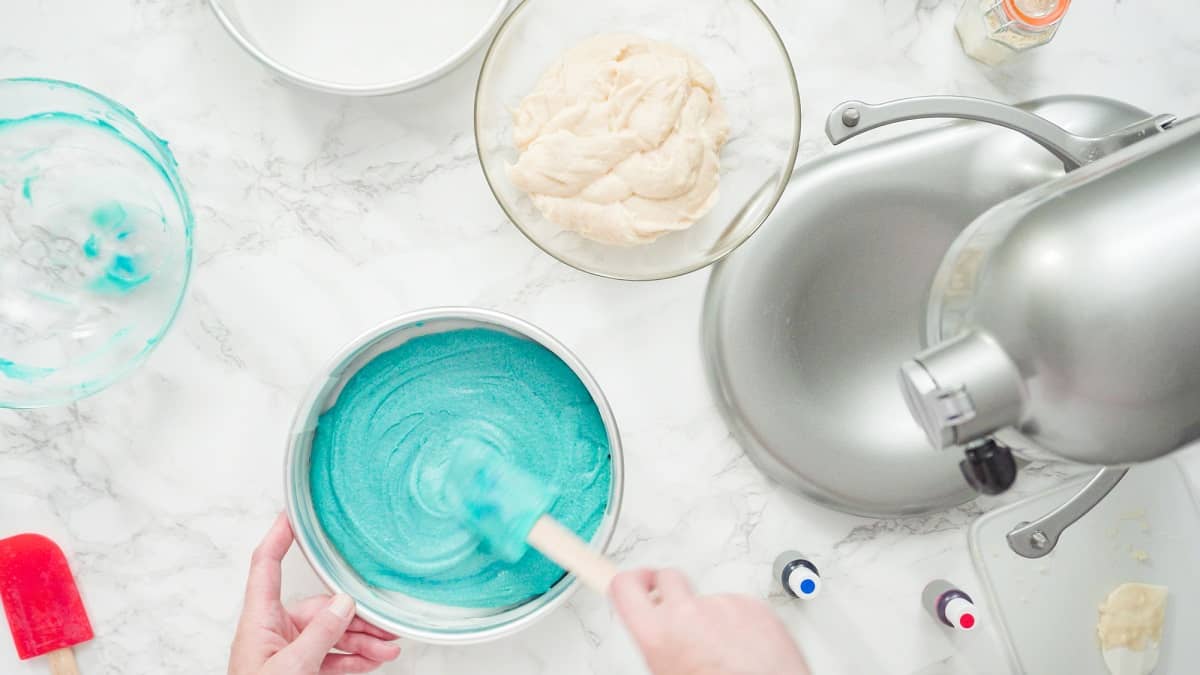 Mixing different colors of frosting.