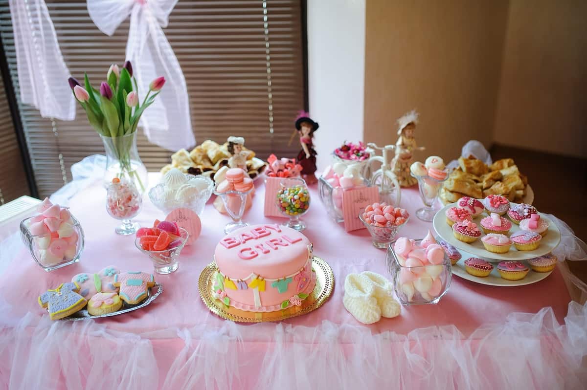 Baby girl cake on a party table.