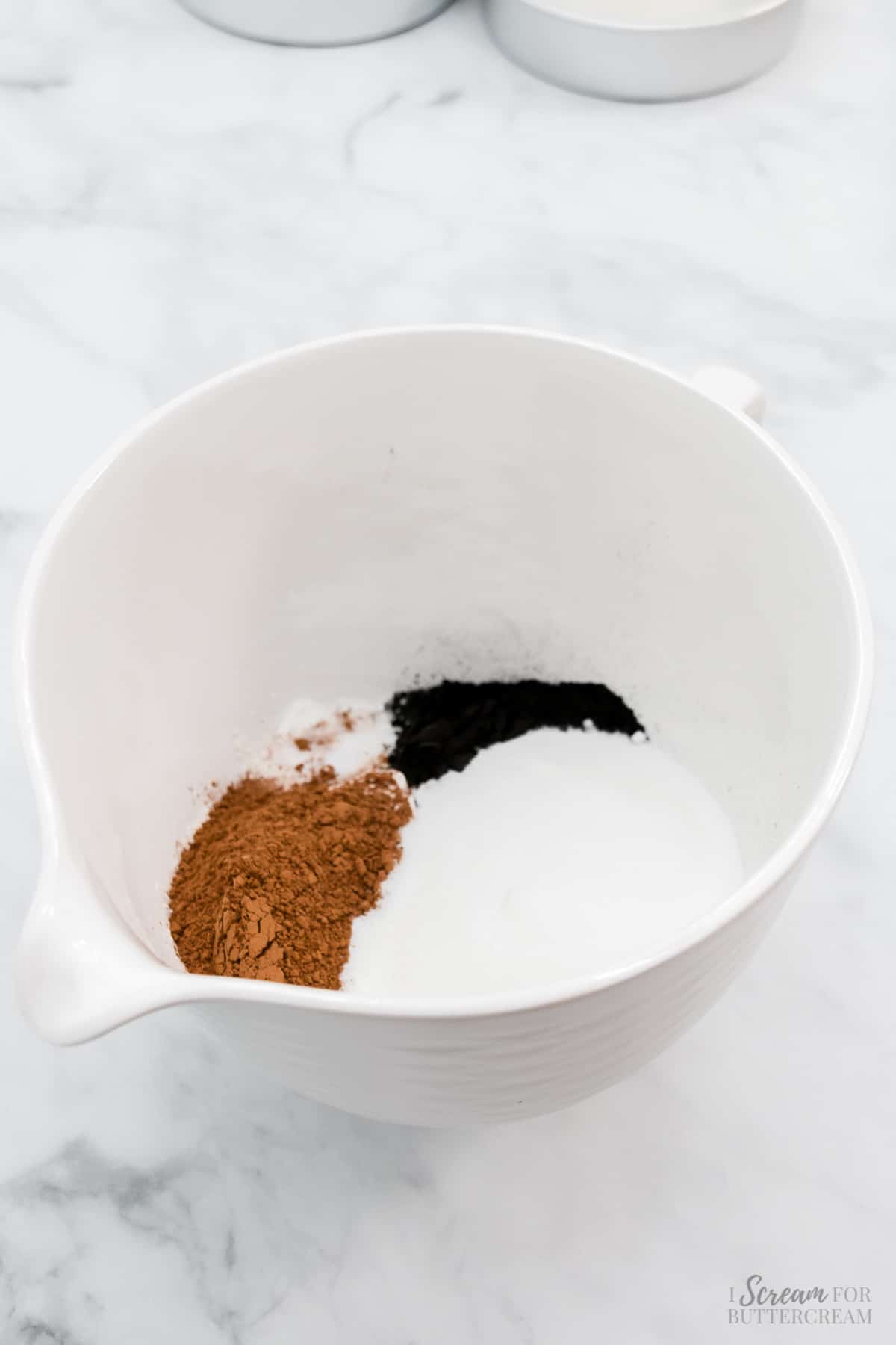 Dry cake batter ingredients in a white bowl.