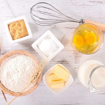 Cake ingredients on a wooden background.