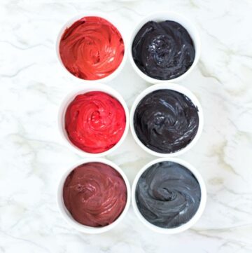 Black and red buttercream in bowls.