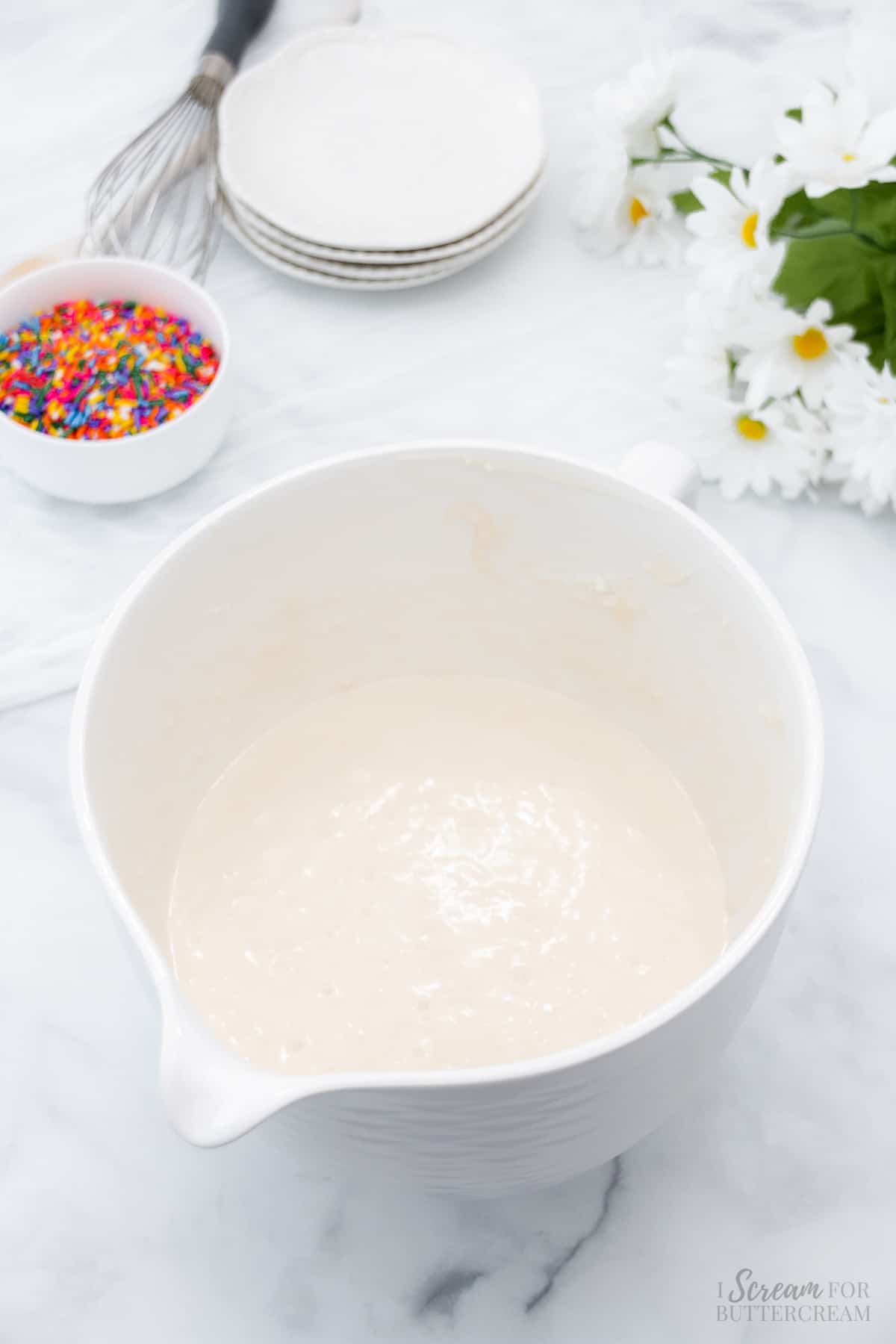 Mixed cake batter in a white bowl.