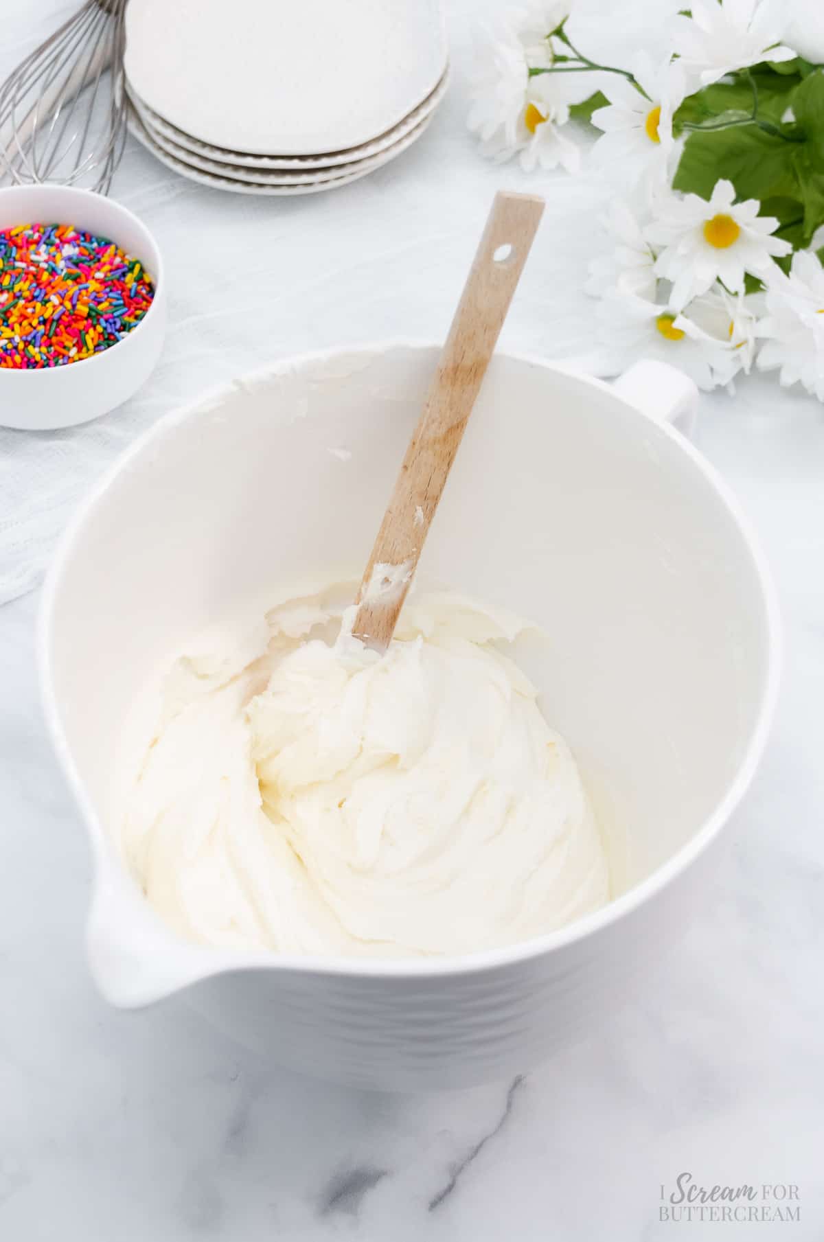 White buttercream in a mixing bowl.