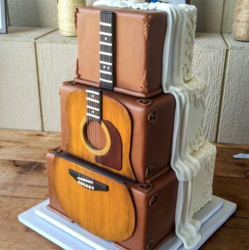 Guitar cake on a table.