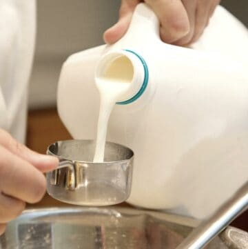 Measuring milk for cake baking.