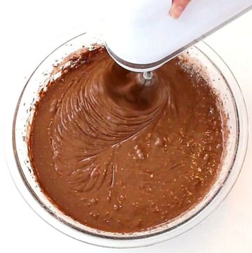 Mixing chocolate cake batter in a bowl.
