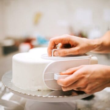 Smoothing fondant on a cake.